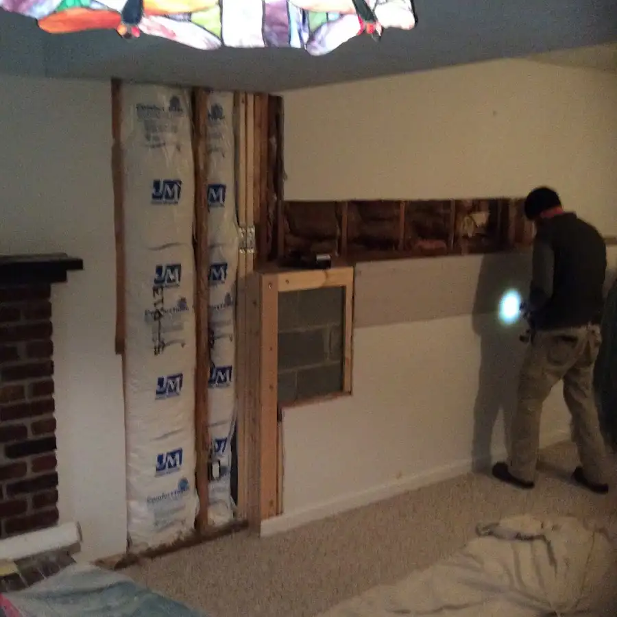 Restoration technician inspecting water damage in Hockessin